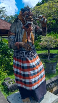 Statue of the god at the entrance to a temple in Bali, Indonesia