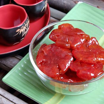 Vietnamese food for Tet holiday in spring, tomato jam, sweet eating is traditional food on lunar new year, can make from tomato cook with sugar,  amazing background for Vietnam custom