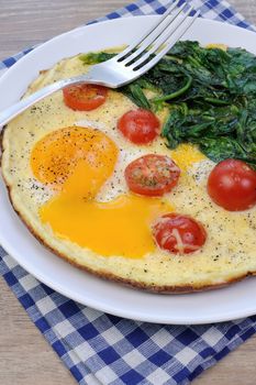 Fried tomatoes and spinach with cheese