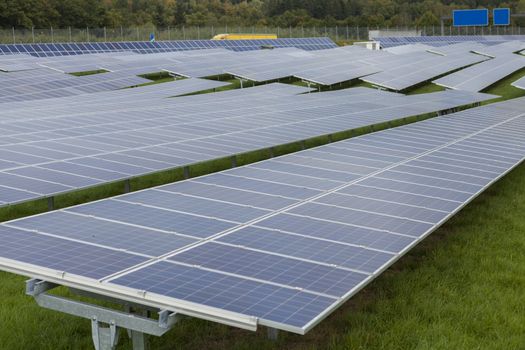 Field with blue siliciom solar cells alternative energy to collect sun energy