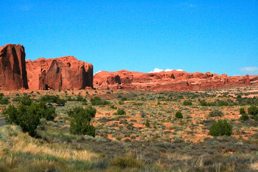 Red rock formations sculpted from wind and rain erosion made from Entrada Sandstone in Arches National Park in Moab Utah, USA.