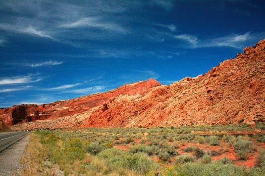 A Utah highway leads visitors to great wonders of red stone in Arches National Park, USA. 