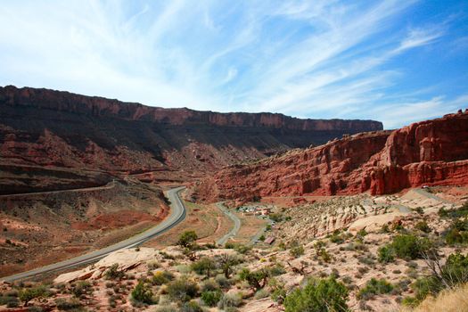 A Utah highway leads visitors to great wonders of red stone in Arches National Park, USA.