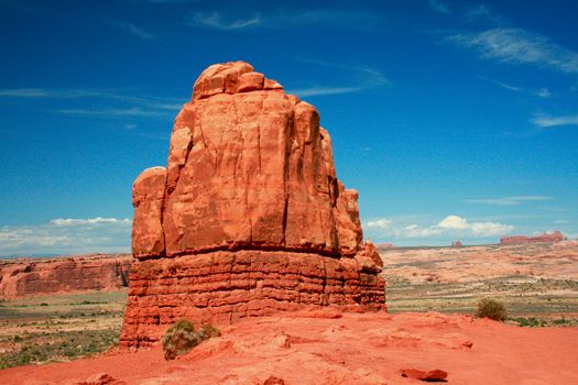 Entrada Sandstone carved for millions of years of weathering result in fantastic shapes in Arches National Park Moab Utah, USA. This monolith is near the Courthouse Towers complex.