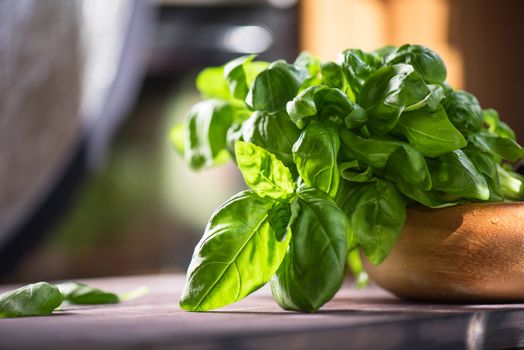 Fresh organic basil leaves on a wooden table