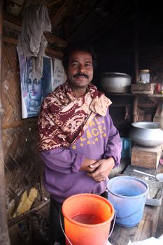 The seller of tea posing in his tea shop in Kumrokhali, West Bengal, India January 14, 2009. Tea is the beverage of choice for many India.