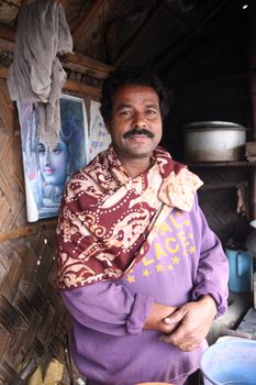 The seller of tea posing in his tea shop in Kumrokhali, West Bengal, India January 14, 2009. Tea is the beverage of choice for many India.