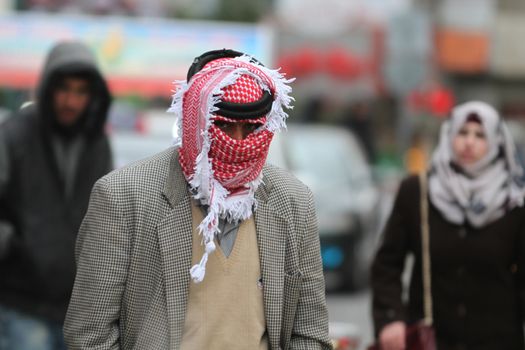 WEST BANK, Bethlehem: A man wearing a headscarf walks on a street, in the Palestinian city of Bethlehem, on January 19, 2016, as a sandstorm hits Israel and West Bank, causing air pollution. A low-pressure system over the Mediterranean has driven the dust northeast from Egypt and the Sinai Peninsula.