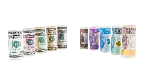 Rolled dollar and polish zloty banknotes isolated on white background with clipping path