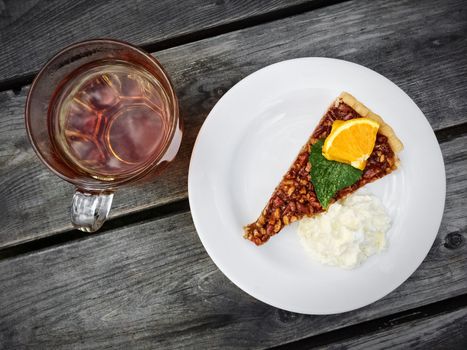 Pecan pie with whipped cream, and a cup of tea.