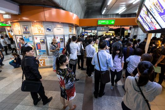 Bangkok, Thailand - January 18, 2016 : Crowd of people walking out from the BTS Mo Chit station to the road in the rush hour at night with the ticket machine in the center. Daily passengers of BTS skytrain is around 700,000