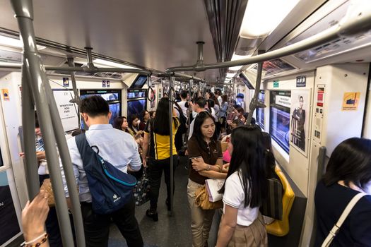 Bangkok, Thailand - January 18, 2016 : crowd of the passengers inside of the BTS skytrain in the rush hour evening. Daily passengers of BTS skytrain is around 700,000