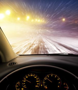 view through car windshield to snow-covered road