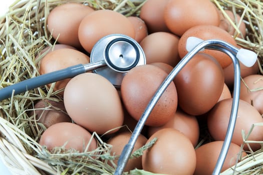 stethoscope and eggs in a basket with straw secondary