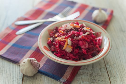 Plate of the Russian salad on the coloured napkin