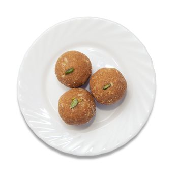 Indian sweets on a plate isolated over white