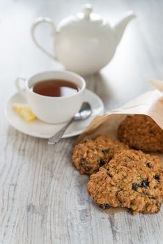 Tea with the oatmeal cookies in the paper bag