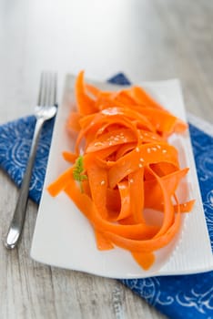 Vitamin carrot salad on the white plate