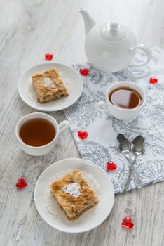 Two pieces of apple pie with tea