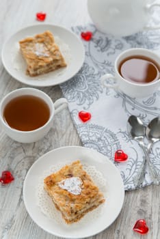 Two pieces of apple pie with tea
