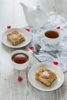 Two pieces of apple pie with tea