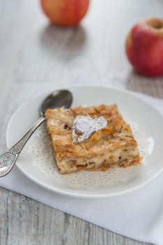 Piece of an apple pie and two apples