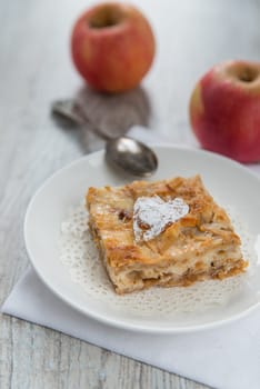 Piece of an apple pie and two apples