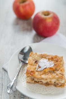 Piece of an apple pie and two apples