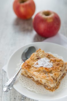 Piece of an apple pie and two apples