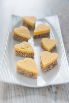 Heart shaped cheese sandwiches on the white plate