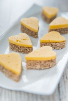 Heart shaped cheese sandwiches on the white plate