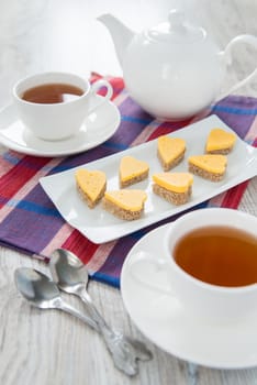 Heart shaped cheese sandwiches with tea