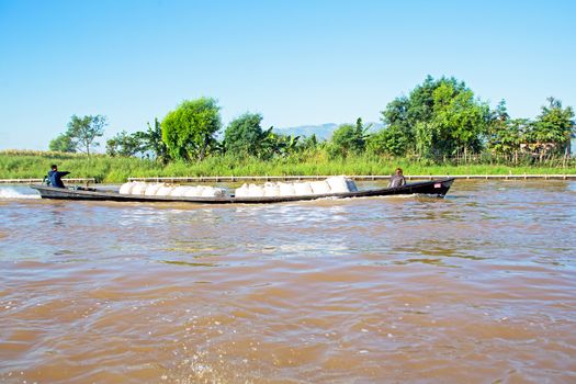 INLE LAKE, MYANMAR - NOVEMBER 15, 2015: Transporting bags of rice at Inle Lake, Myanmar on the 15th November, 2015