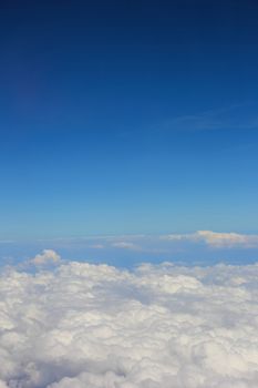 Soft clouds over view from airplane flying