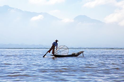 Silhouette of fisherman at sunset Inle Lake Burma Myanmar

