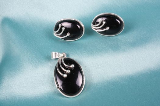 A silver jewelery set of pendant and earrings with black onyx gemstone
