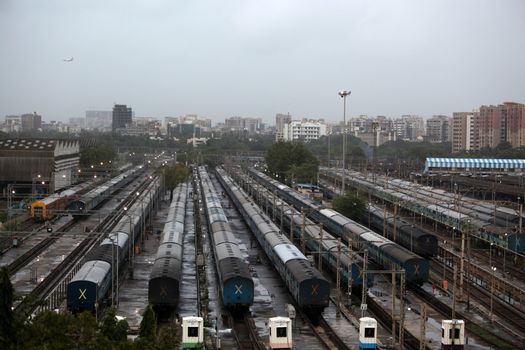 A birds eye view of trains at a railway junction in Mumbai, India on a rainy evening.