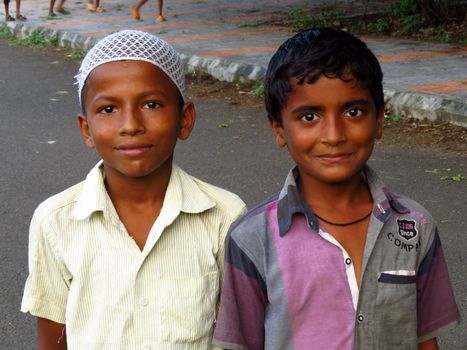 A metaphorical image of a small Indian Hindu and Muslim Boy together showing communal harmony among two religions.                               
