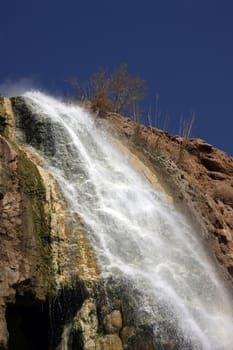 Waterfall and dark blue clear sky