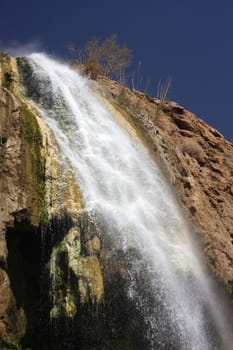 Waterfall and dark blue clear sky