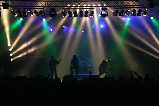 People with hands in the air on a big festival show