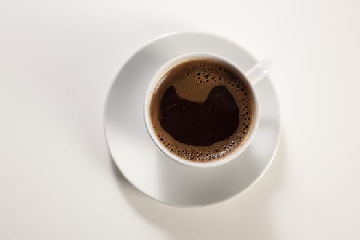 A cup for coffee on white table from above