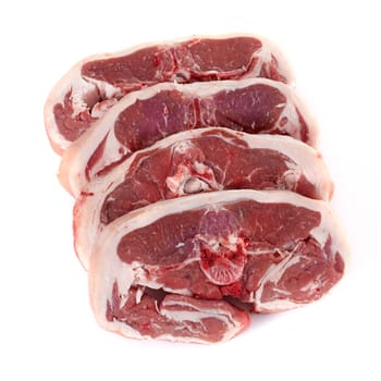 four lamb chops in front of white background