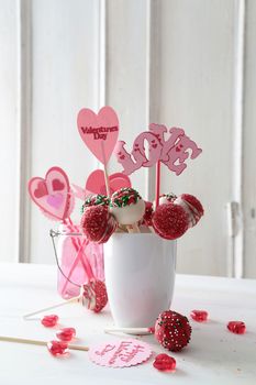 Cake pops with decorations on kitchen table