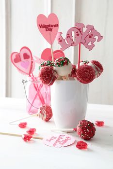 Closeup of cake pops with decorations on kitchen table