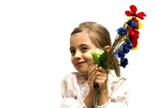 smiling little girl with a bouquet of flowers isolated on a white background