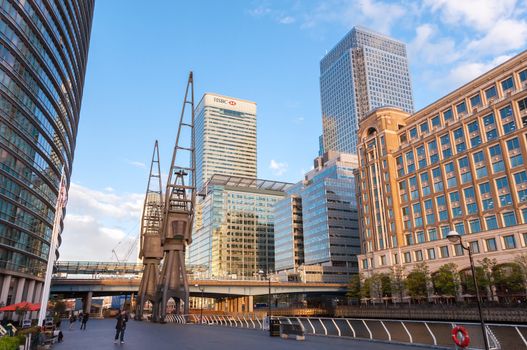 London, United Kingdom - May 9, 2011: HSBC's world Head Quarters building and old port cranes part of the redevelopment around Canary Wharf in the London Docklands.