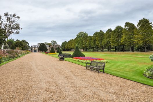 London, United Kingdom - AUGUST 26, 2009: View of beautiful alley in Hampton Court gardens. It was originally built for Cardinal Thomas Wolsey, a favorite of King Henry VIII.