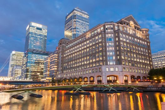 London, United Kingdom - May 9, 2011: Illuminated modern buildings in North Dock in London's docklands at night. Canary Wharf is one of London's two main financial centres.