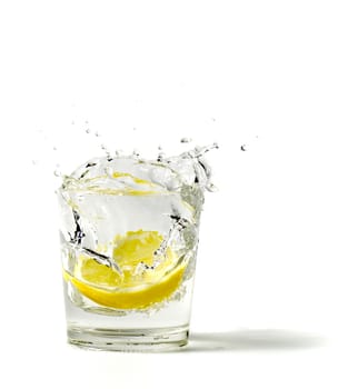 lemon splashing in glass on a white background